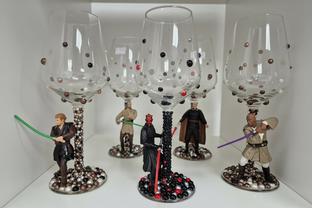 Wine glasses with Star Wars-themed bases featuring figures.