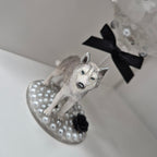 Dog figurine on a large stemmed glass with a black bow