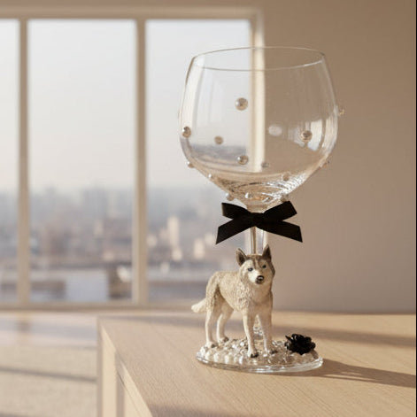 Decorative wine glass with a husky figurine, black bow and pearls.