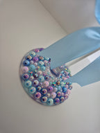 Decorative item with colorful beads on a white background