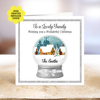 Personalised Christmas Card. The card has a silver glitter border, a snow globe illustration with a winter village scene, and the text 'To a Lovely Family Wishing you a Wonderful Christmas' and 'The Smiths.