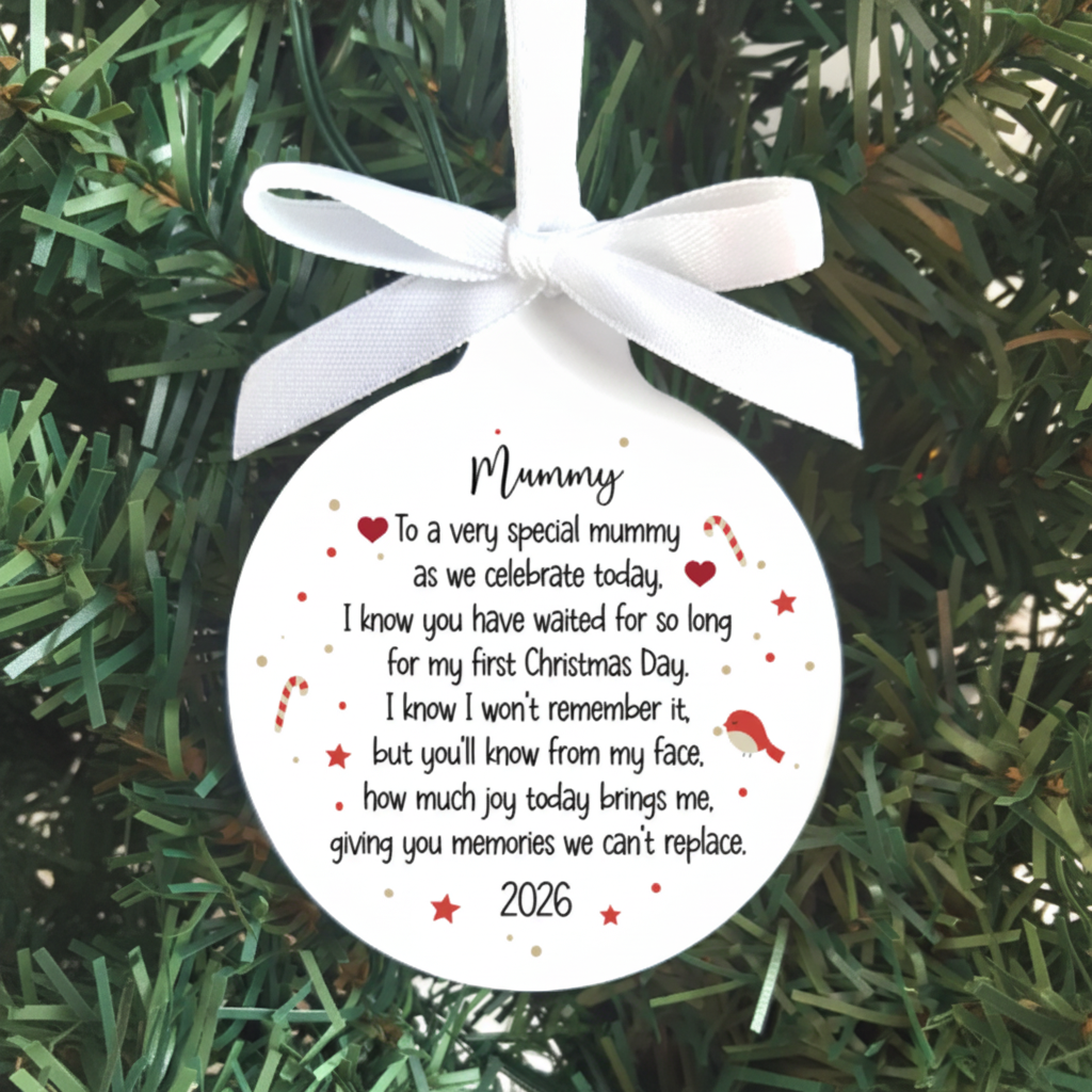 A personalized round Christmas ornament hanging on a green Christmas tree. The ornament is white with a white ribbon bow at the top and features a printed sentimental message for 'Mummy' with small red hearts, candy canes, and a Santa graphic.