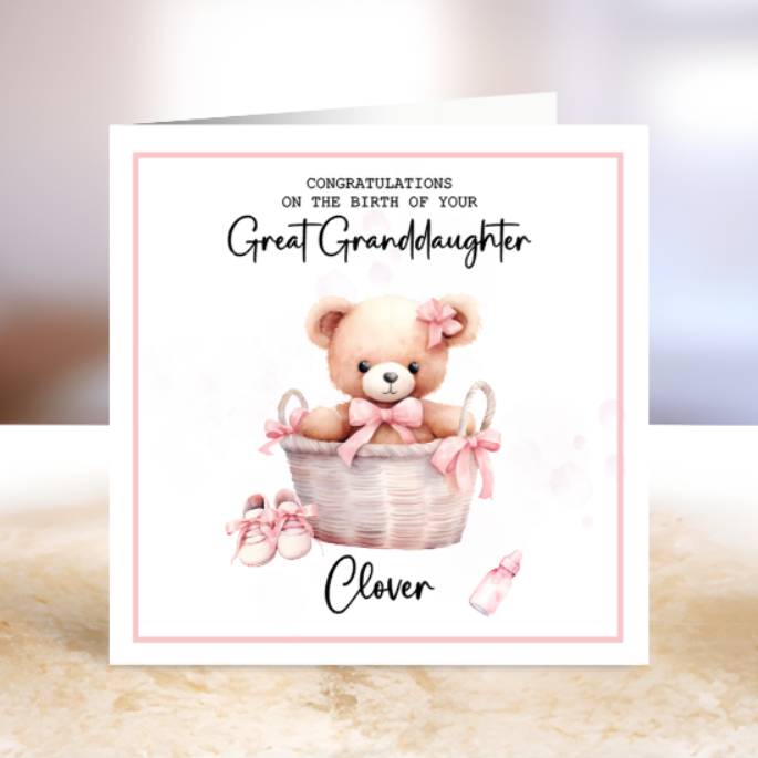 Greeting card with a teddy bear in a basket and text 'Congratulations on the birth of your great granddaughter.