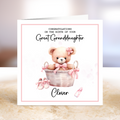 Greeting card with a teddy bear in a basket and text 'Congratulations on the birth of your great granddaughter.