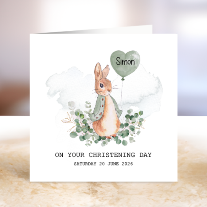 Greeting card with a rabbit character holding a heart-shaped balloon, on a textured surface.