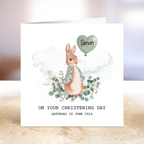 Greeting card with a rabbit character holding a heart-shaped balloon, on a textured surface.