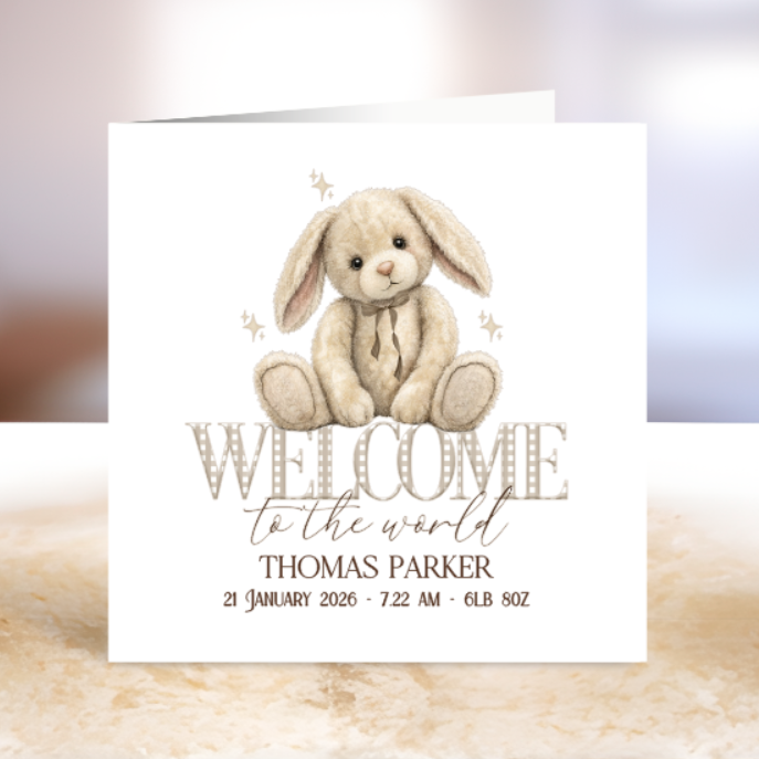 Newborn announcement card with a rabbit illustration and text on a white background.